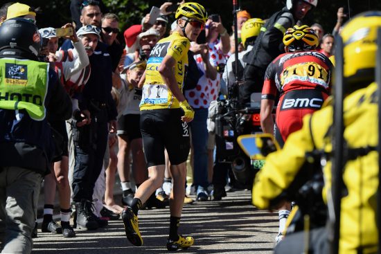 Great Britain's Christopher Froome (C), wearing the overall leader's yellow jersey, runs to get another bike after falling during the 178 km twelvelth stage of the 103rd edition of the Tour de France cycling race on July 14, 2016 between Montpellier and Chalet-Reynard. / AFP PHOTO / JEFF PACHOUD