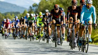 UTENFOR: Andreas Vangstad (i midten) og lagkameratene lå mannsterke i front av feltet under tredje etappe i Arctic Race of Norway 2015. I år er det usikkert om Sparebanken Sør får delta i rittet.
