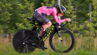 Britain's rider of team Mitchelton-Scott Simon Yates celebrates the pink jersey of the overall leader on the podium after winning the 15th stage between Tolmezzo and Sappada of the 101st Giro d'Italia